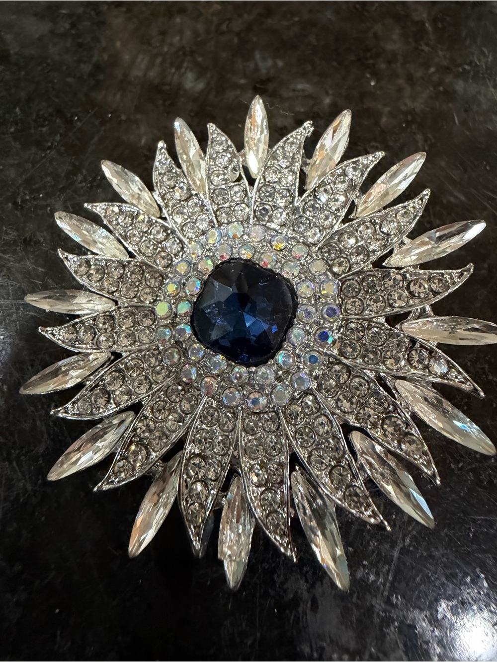 Sparkling Sunburst Rhinestone Brooch with Deep Blue Center